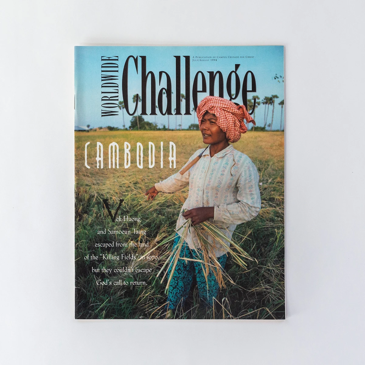 Cru's Worldwide Challenge magazine, depicting a woman standing in a field in Cambodia, designed by Journey Group